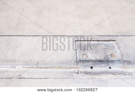 Drain cover with the dust near the concrete street in the urban villageCopy space.
