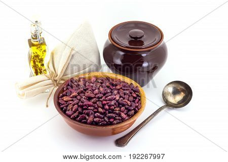 The Composition Of The Red Beans In A Clay Pial Next To A Clay Pot And A Copper Spoon,