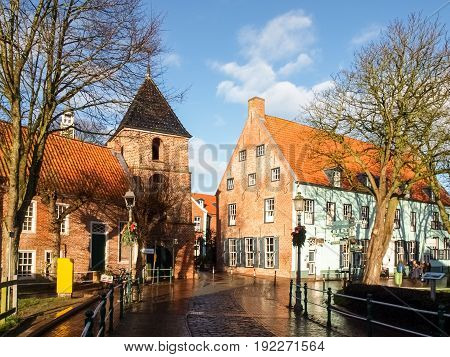 Greetsiel, Germany - December 6, 2014: Tourist town maintained as in antiquity. The typical houses are built of red brick. In the village there is a small harbor.