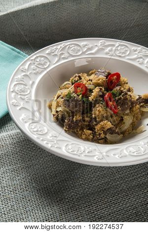 Farofa with dried meat and pepper. Gourmet food.