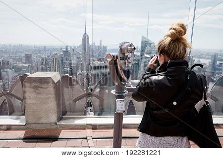 Tourist taking photos of New Yorks skyline on view point