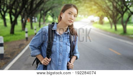 women asian with bright backpack of the tourist traveler on nature