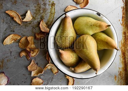 Top view: dried apples and pears in bowls. Rustic vintage style. Countryside