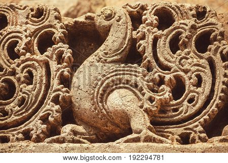 Artwork on the Hindu temple walls with friezes mythical swans and designed patterns. 12th centur Hoysaleshwara temple in Halebidu, India
