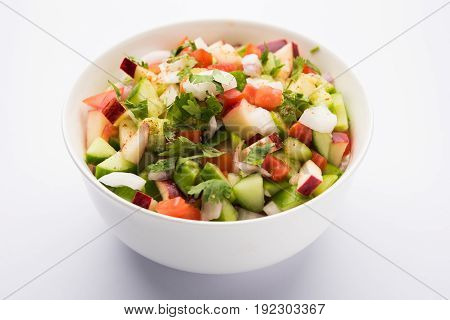 Indian Green Salad also known as Kachumber is a colourful salad dish in Indian cuisine consisting of fresh chopped tomatoes, cucumbers, onions, and sometimes, chili peppers. selective focus