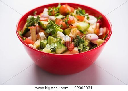 Indian Green Salad also known as Kachumber is a colourful salad dish in Indian cuisine consisting of fresh chopped tomatoes, cucumbers, onions, and sometimes, chili peppers. selective focus