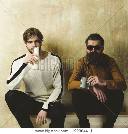 Friends In Casual Wear Drinking Beverages On Wooden Stairs