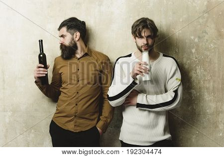 Friends With Drinks Standing On Beige Wall