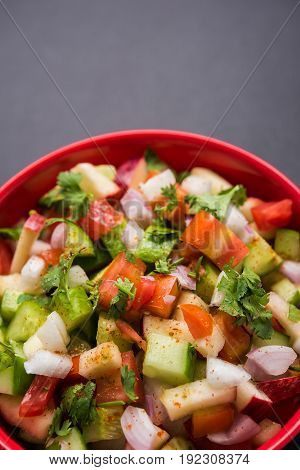 Indian Green Salad also known as Kachumber is a colourful salad dish in Indian cuisine consisting of fresh chopped tomatoes, cucumbers, onions, and sometimes, chili peppers. selective focus