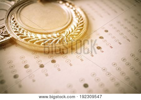 medals awards on exam test answer sheet education and winner award concept vintage tone
