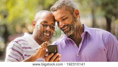 Happy Lgbt Gay Couple Looking At Pictures On Mobile Phone