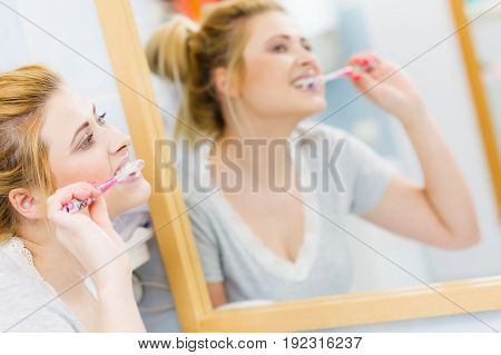 Woman Brushing Cleaning Teeth In Bathroom