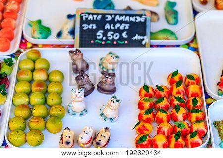 Colorful marzipan or almond paste candy made to look like fruits and vegetables and a market in Nice France.