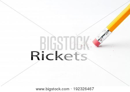 Closeup of pencil eraser and black Rickets text.  