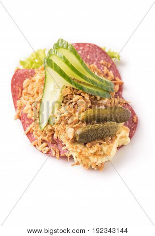 Danish specialties and national dishes high-quality open sandwich Salami with crispy fried onion remoulade and cucumber isolated on white background