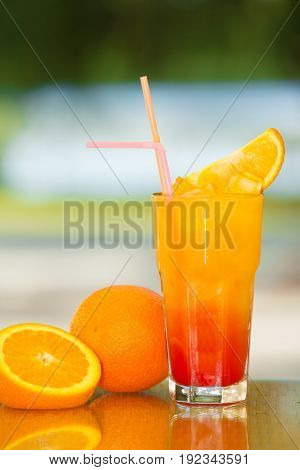 Non-alcoholic drink and fruit on a table with a blurred background.