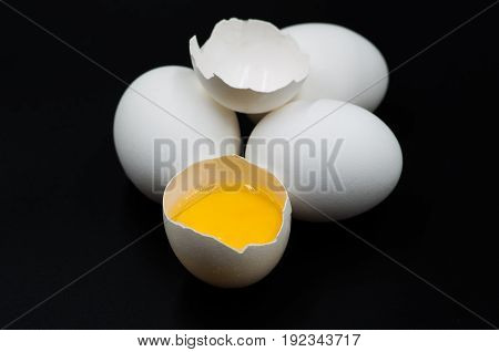fresh eggs with yellow yalk on the black background