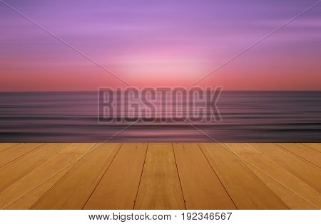 wood floor on sea with purple sunset Burning Skie beautiful natural tropical sea