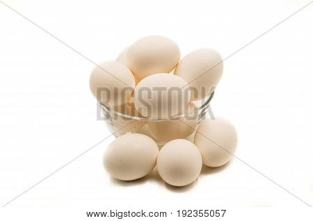 fresh brown eggs in a crystal bowl on the white background