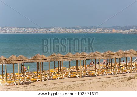 ALVOR, PORTUGAL - APRIL 23, 2017: People at the famous beach of Praia do Alvor, Algarve region, Portugal
