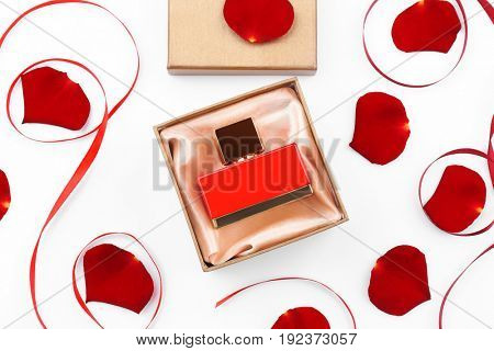 Perfume in present box on white background
