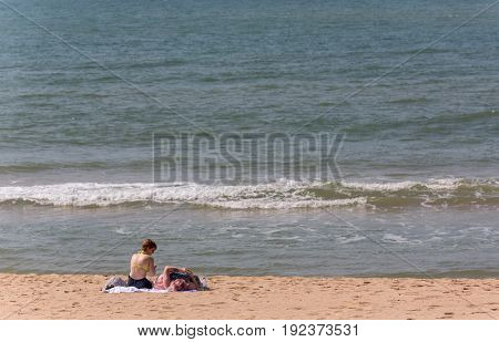 ALVOR, PORTUGAL - APRIL 23, 2017: People at the famous beach of Praia do Alvor, Algarve region, Portugal