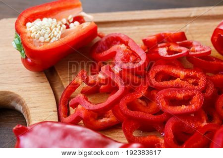 Sweet red pepppers on wooden surface. Raw vegetarian food.