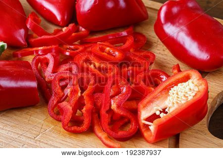 Sweet Red Pepppers On A Wooden Board