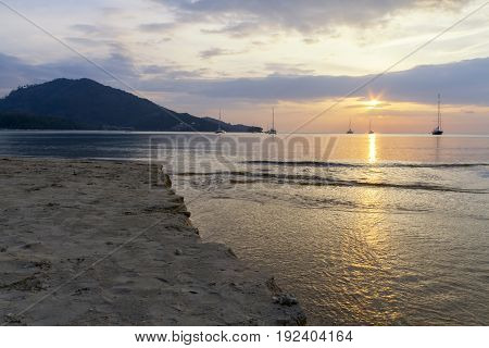 Beautiful sunset on the beach at Naiyang, Phuket, Thailand