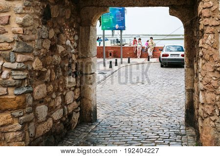 Tourists Near Gateway To Ria Formasa In Faro