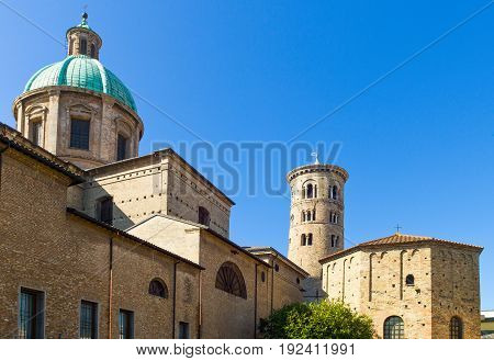 Italy Ravenna the Battistero Degli Ortodossi (or Neoniano) and in the background the Cathedral bell tower. the Cathedral dome and bell tower.