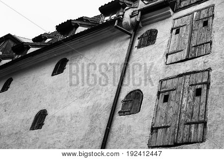 Wall Of Medieval House With Wooden Blinds In Riga