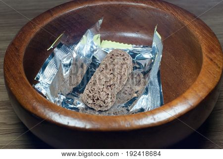 Oatmeal in a wood cup with wood patterned background.