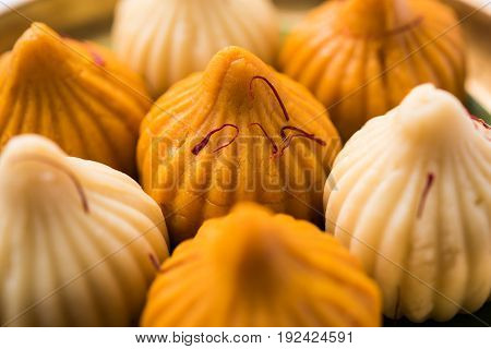 A modak is an Indian sweet dumpling popular in many parts of India. It is called modak in Marathi and Konkani as well as Gujarati language, Kozhakkatta in Malayalam, modhaka or kadubu in Kannada