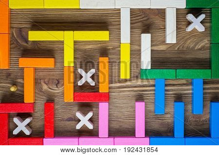 Man in the labyrinth the search for the exit top view. The concept of a business strategy analytics search for solutions the search output. Maze of colorful wooden blocks flat lay.