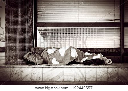 Homeless. Homeless barefooted woman sleep on the street. Social documentary street.