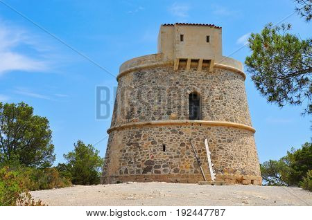a view of the medieval tower Torre de Campanitx or Torre den Valls, in Ibiza, Spain