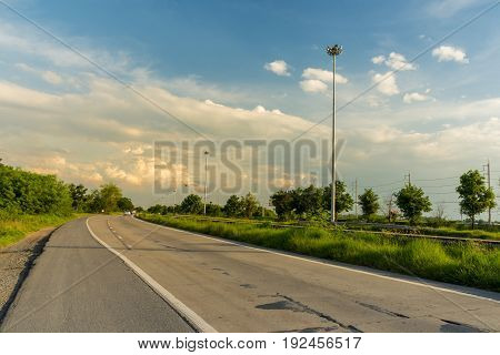 Comfortable journey of beautiful landscape street and trees beside with blue sky and clouds on sunlight.
