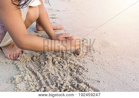 Child hands Play sand on the beach