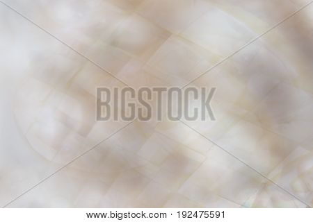 Beautiful abstract dreamy blurred mother of pearl background with peach and lilac colours