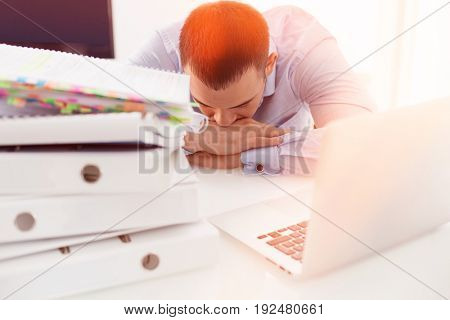 Close-up view of Caucasian businessman asleep at his desk
