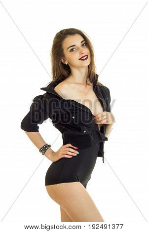 Vertical portrait of cheerful girl in black jacket and high panties smiling on camera isolated on white background