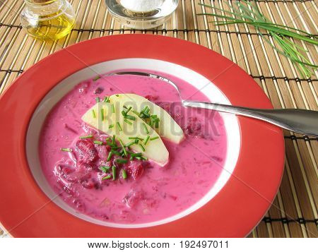 Homemade cold beetroot soup with herbs on plate