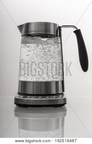 Kettle with boiling water on the table