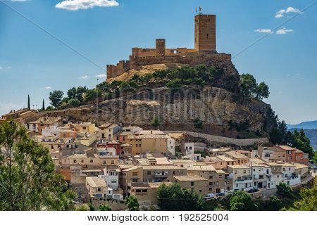 Top of the hill with Biar castle and town at dusk in Alicante, Spain