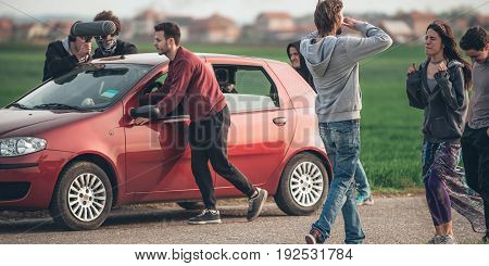 Behind Scene Improvisation. Film Crew Team Pushing Car With Cameraman