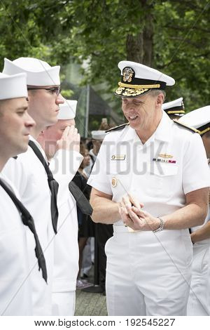 ADM Phil Davidson CDR US Fleet Forces Command gives challenge coins and handshakes to personnel at re-enlistment and promotion ceremony, National Sept 11 Memorial site Fleet Week NEW YORK MAY 26 2017