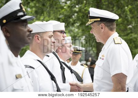 ADM Phil Davidson CDR US Fleet Forces Command gives challenge coins and handshakes to personnel at re-enlistment and promotion ceremony, National Sept 11 Memorial site Fleet Week NEW YORK MAY 26 2017