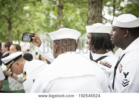 Participating U.S. Navy sailors pose for a photograph together after the re-enlistment and promotion ceremony at the National September 11 Memorial site. Fleet Week, NEW YORK MAY 26 2017