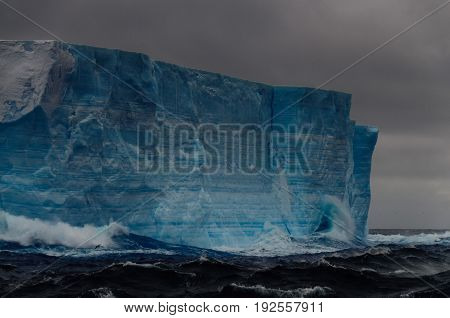 A large tabular iceberg floating in the southern atlantic ocean, near Antarctica.